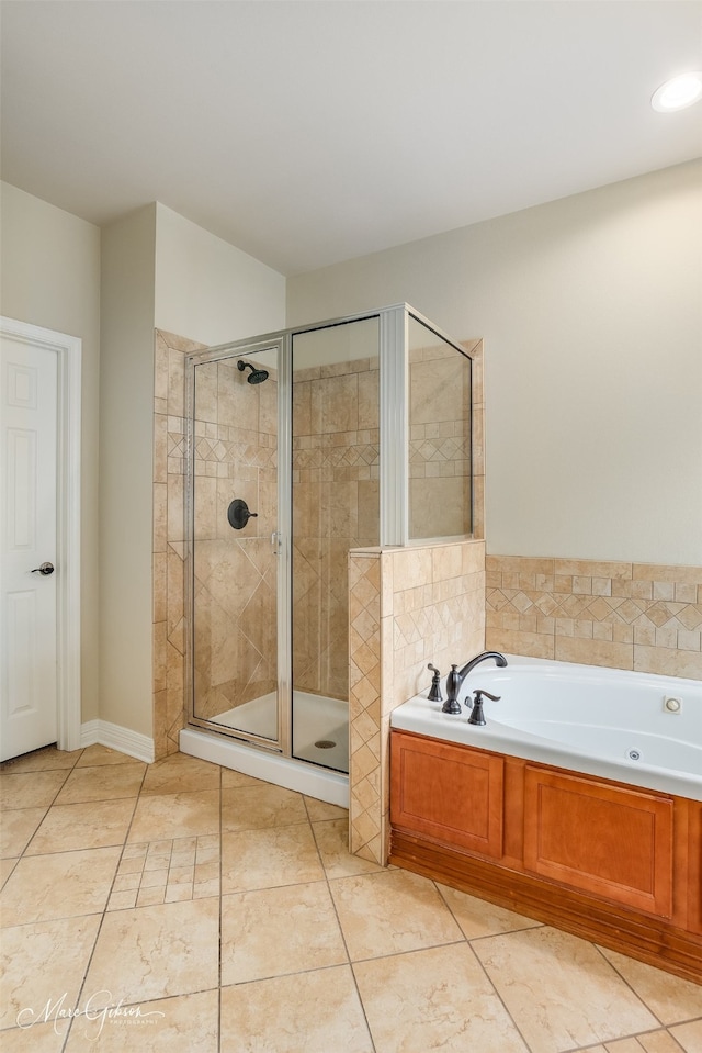 bathroom featuring tile patterned flooring and plus walk in shower