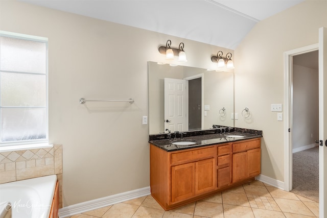 bathroom with tile patterned floors, a healthy amount of sunlight, lofted ceiling, and a tub to relax in