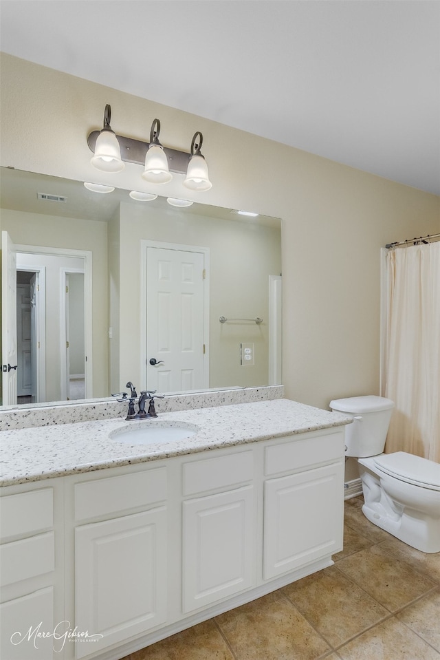 bathroom with a shower with curtain, tile patterned flooring, vanity, and toilet