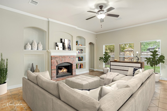 living room with a fireplace, ceiling fan, built in features, and light tile patterned flooring