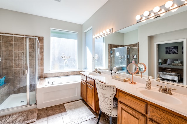 bathroom with plus walk in shower, a wealth of natural light, and vanity