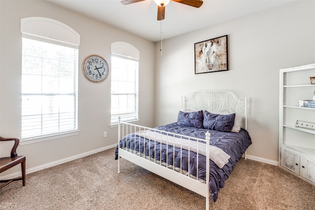 bedroom with ceiling fan and light colored carpet