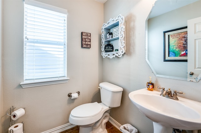 bathroom featuring sink, tile patterned flooring, and toilet