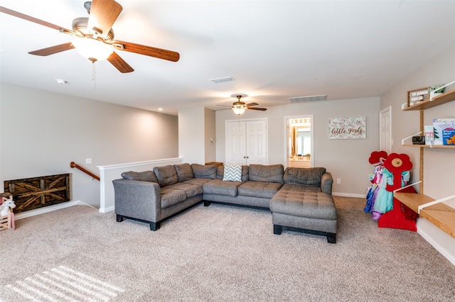 living room featuring ceiling fan and carpet