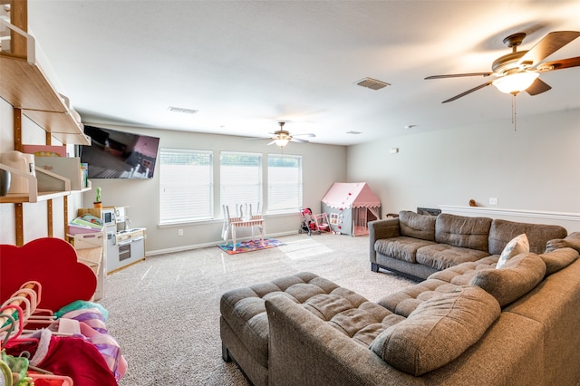 carpeted living room with ceiling fan