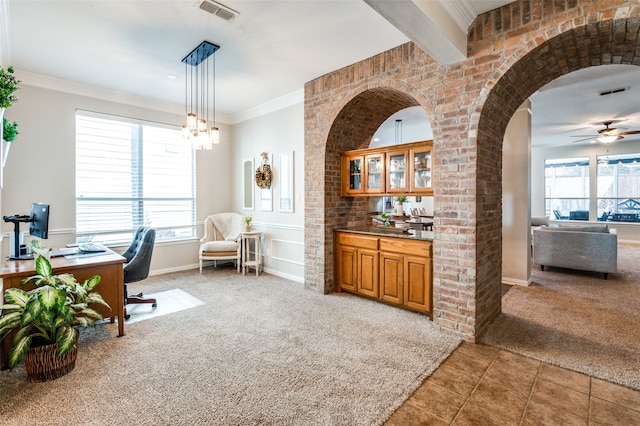 office space with carpet, ornamental molding, and ceiling fan