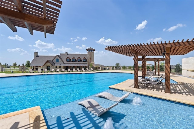 view of swimming pool featuring pool water feature, a pergola, and a patio