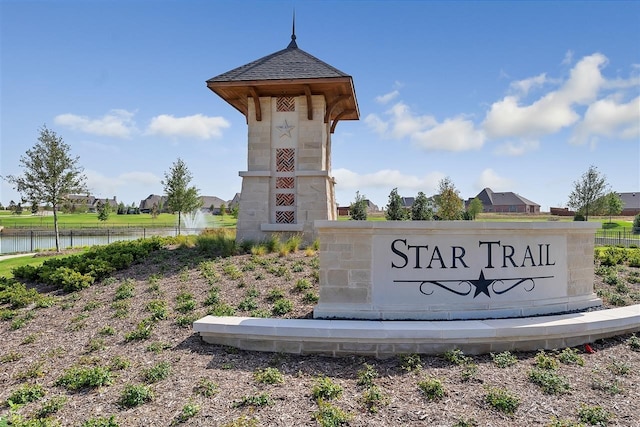 community sign with a water view