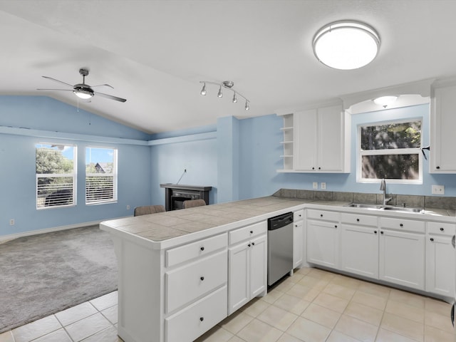 kitchen with kitchen peninsula, white cabinetry, light colored carpet, and stainless steel dishwasher