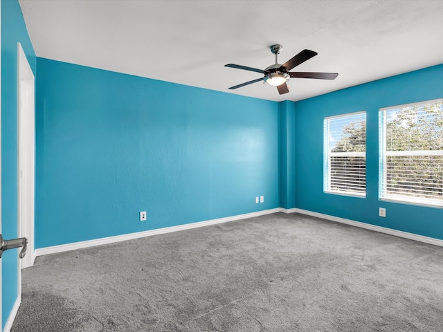 carpeted empty room featuring ceiling fan