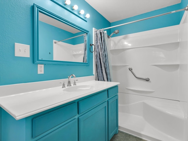 bathroom featuring a shower with shower curtain, vanity, and tile patterned flooring