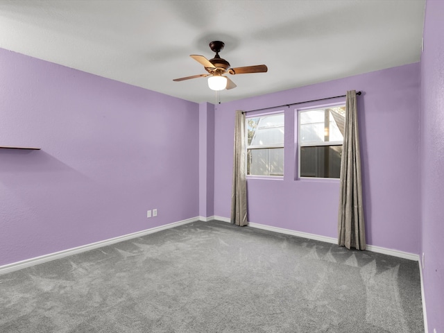 spare room featuring carpet and ceiling fan