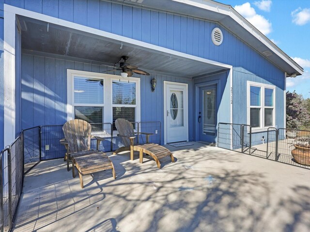 view of exterior entry featuring a patio area and ceiling fan