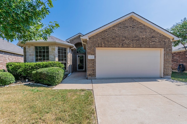 view of front of property with a front yard and a garage