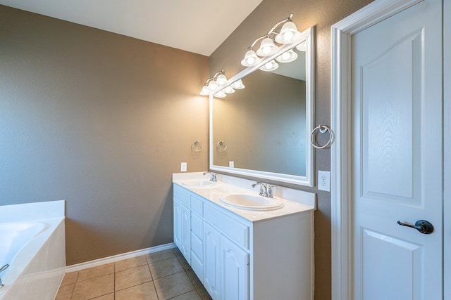 bathroom featuring a tub to relax in, vanity, and tile patterned floors