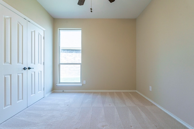 carpeted empty room with ceiling fan and a healthy amount of sunlight