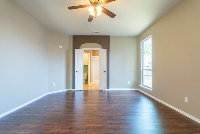 empty room featuring ceiling fan and dark hardwood / wood-style floors