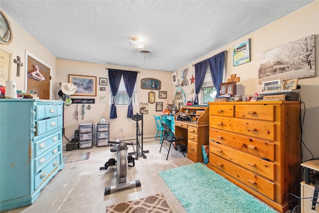 workout room featuring a textured ceiling