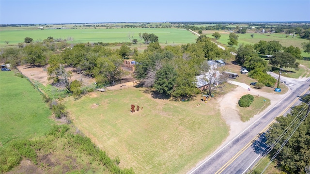 birds eye view of property with a rural view