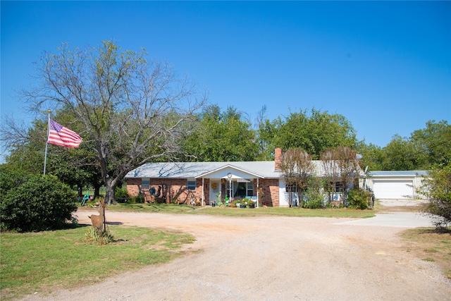 ranch-style house with a porch, a garage, and a front lawn