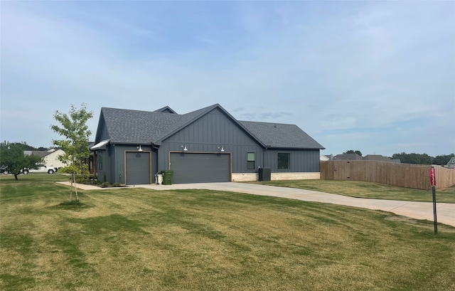 modern inspired farmhouse with a front yard, a garage, and central air condition unit