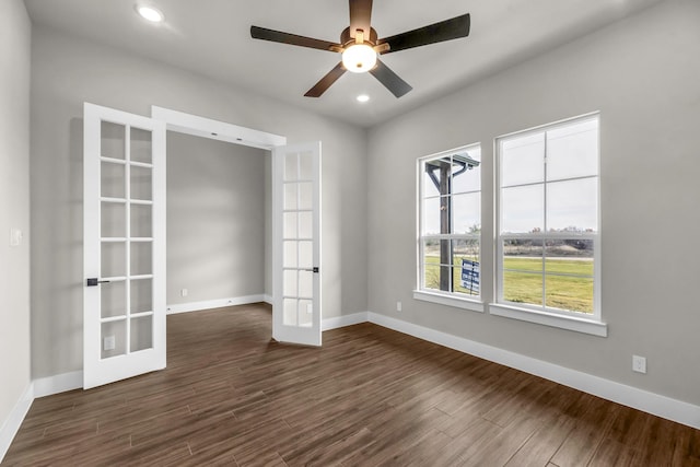 spare room with dark hardwood / wood-style flooring, ceiling fan, and french doors