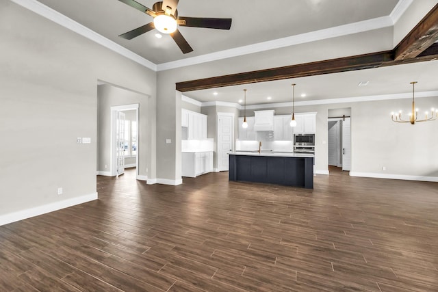 kitchen with a center island with sink, white cabinets, dark wood-type flooring, and decorative light fixtures