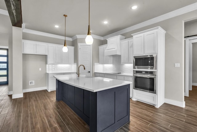 kitchen featuring white cabinetry, sink, dark hardwood / wood-style floors, a center island with sink, and appliances with stainless steel finishes