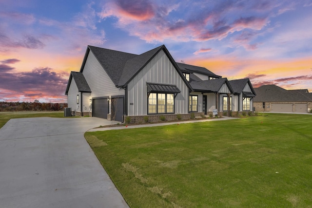 modern farmhouse style home featuring central AC, a garage, and a lawn