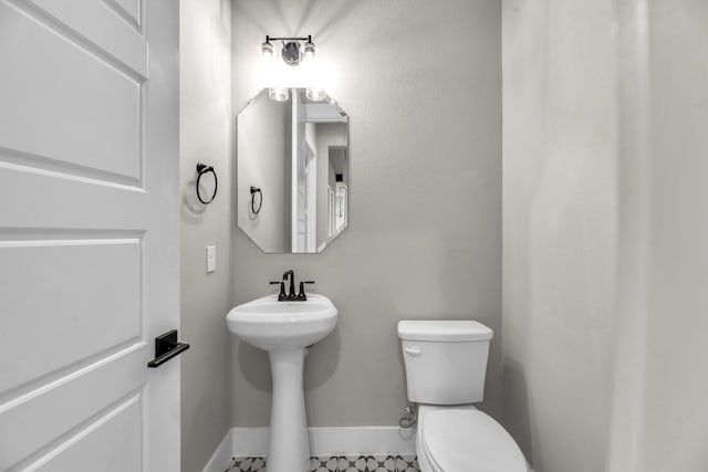 bathroom with tile patterned flooring and toilet