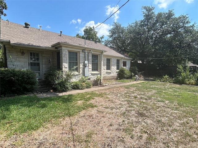 ranch-style home with a front lawn