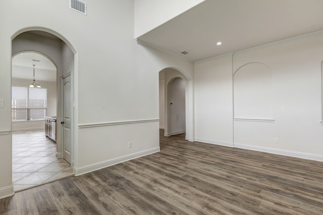 empty room with dark hardwood / wood-style flooring and ornamental molding