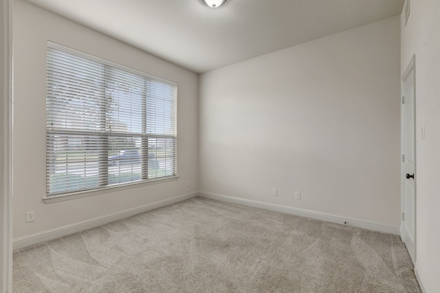 unfurnished room with light carpet