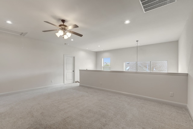 unfurnished room featuring light colored carpet and ceiling fan