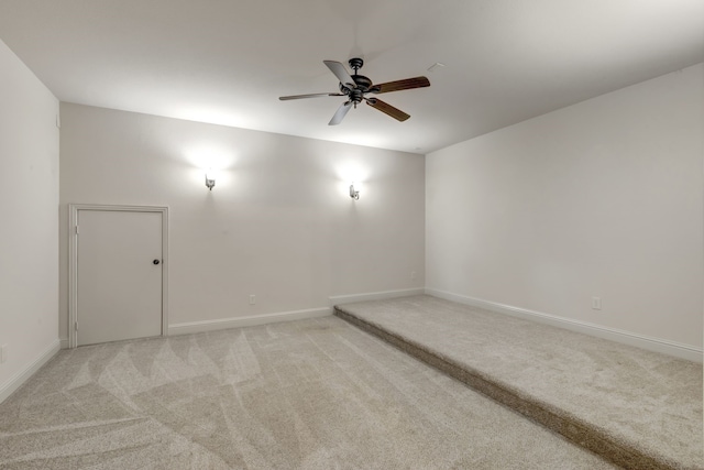 carpeted spare room featuring ceiling fan