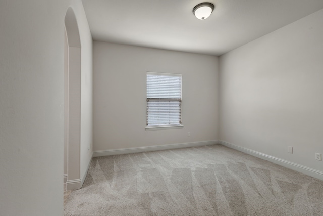 unfurnished room with light colored carpet