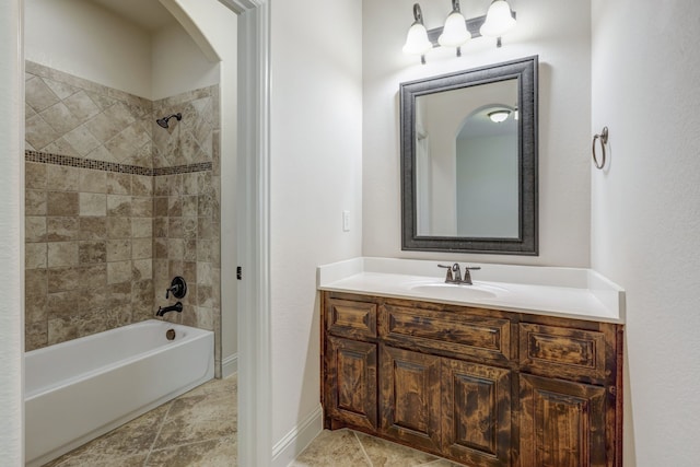 bathroom with tiled shower / bath and vanity