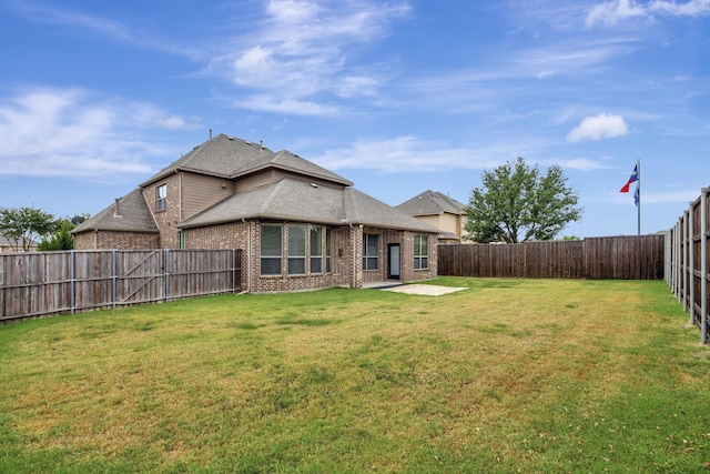 back of property featuring a lawn and a patio