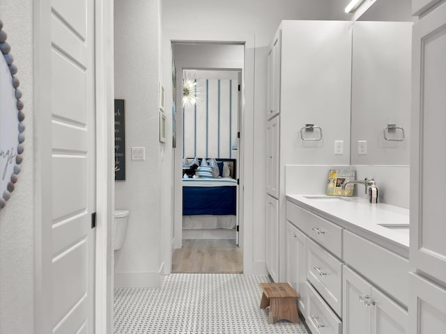 bathroom featuring vanity, tile patterned flooring, and toilet