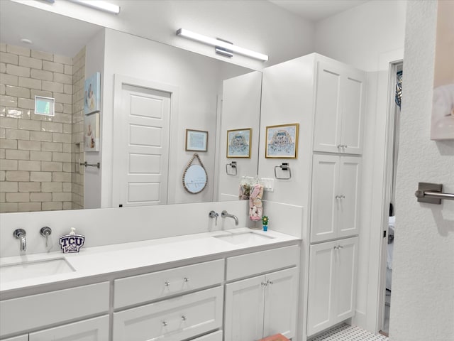 bathroom featuring vanity, a tile shower, and tile patterned floors