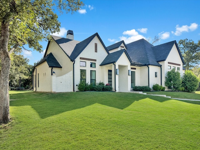 french country home featuring a front yard