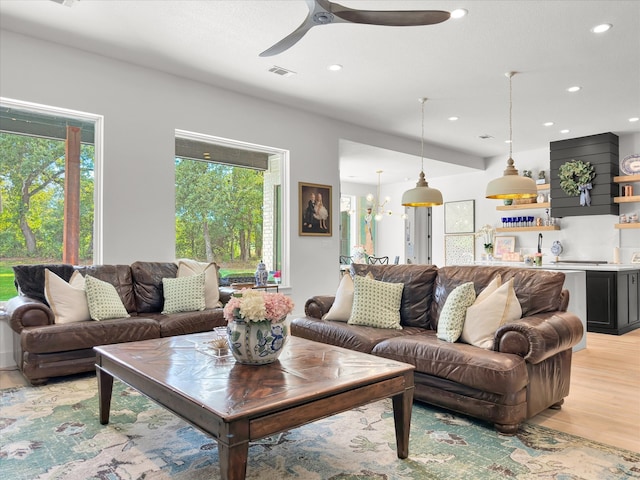 living room featuring light wood-type flooring and ceiling fan