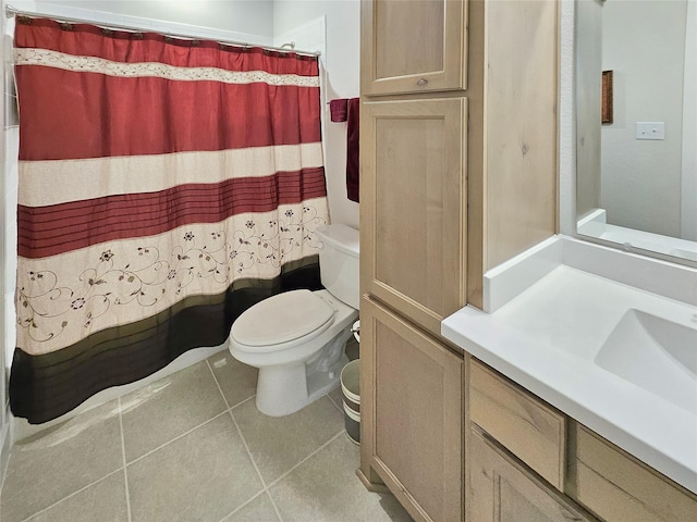 full bathroom with tile patterned flooring, shower / tub combo, vanity, and toilet