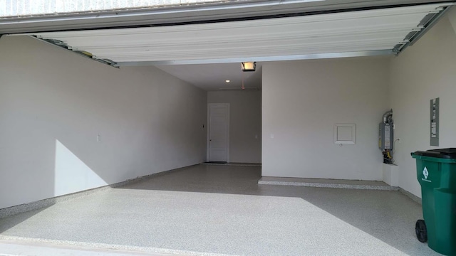 garage featuring a garage door opener and water heater