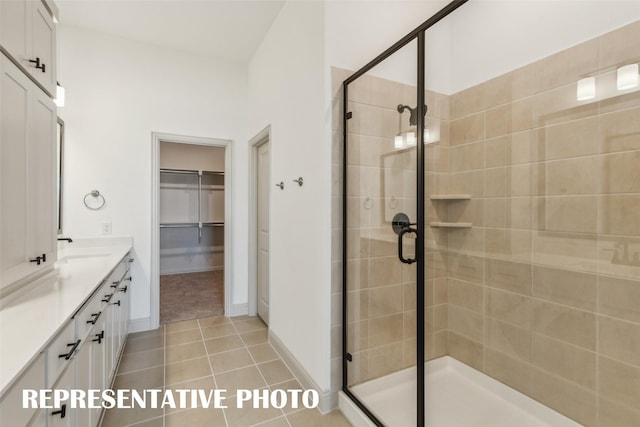 bathroom featuring tile patterned floors, vanity, and an enclosed shower