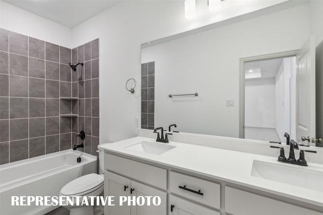 full bathroom featuring tiled shower / bath combo, toilet, and vanity