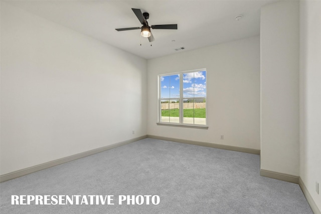 carpeted empty room featuring ceiling fan