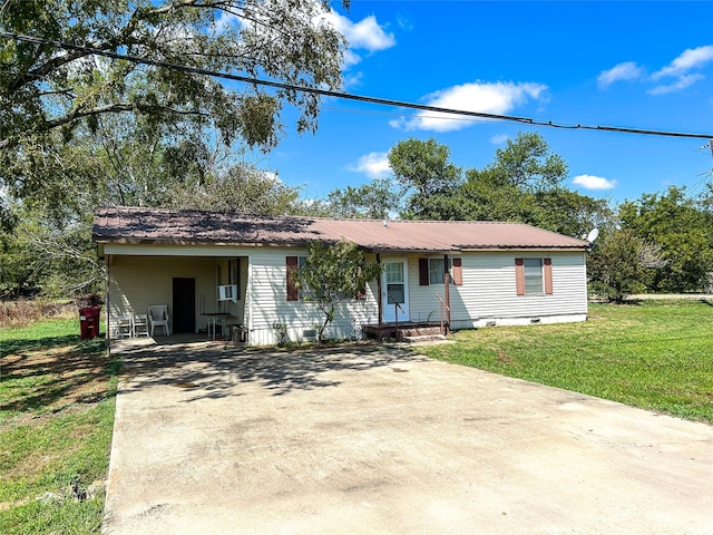 ranch-style house featuring a carport and a front yard