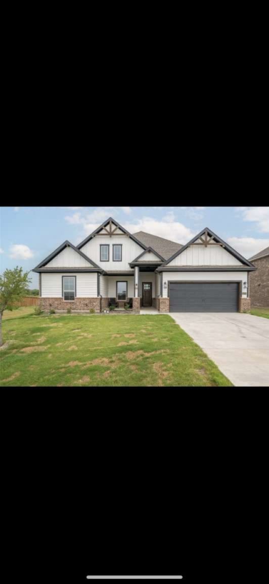 view of front of house with a garage and a front lawn