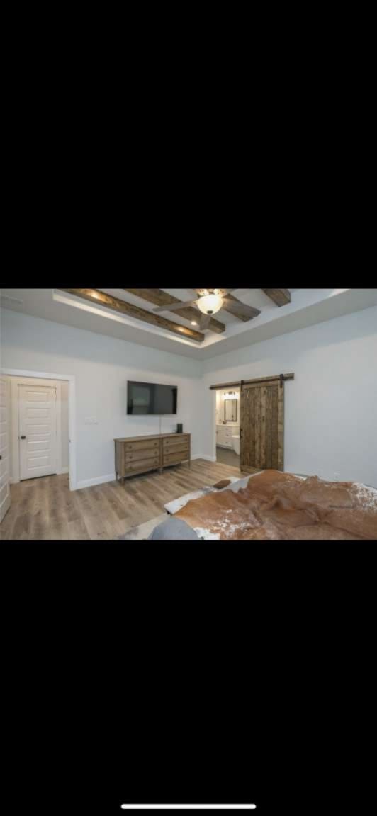 interior space featuring coffered ceiling, hardwood / wood-style flooring, beam ceiling, and ceiling fan